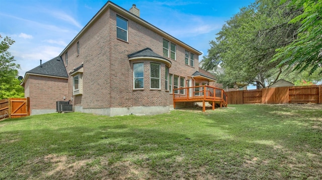 2310 Dervingham Dr, Cedar Park, TX 78613 - rear view of house featuring brick siding, a deck, a fenced backyard, and a chimney