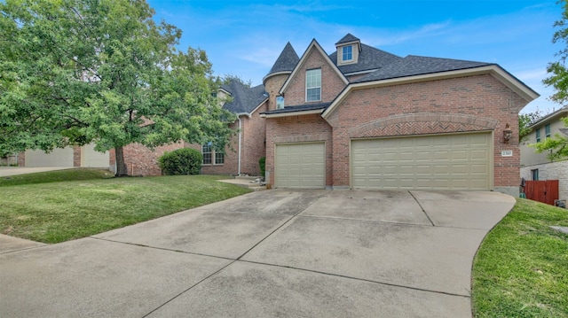 2310 Dervingham Dr, Cedar Park, TX 78613 - view of front facade with brick siding, driveway, a front yard, and a shingled roof