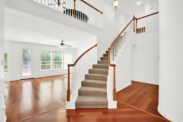 2310 Dervingham Dr, Cedar Park, TX 78613 - staircase featuring hardwood / wood-style flooring, a ceiling fan, and a towering ceiling