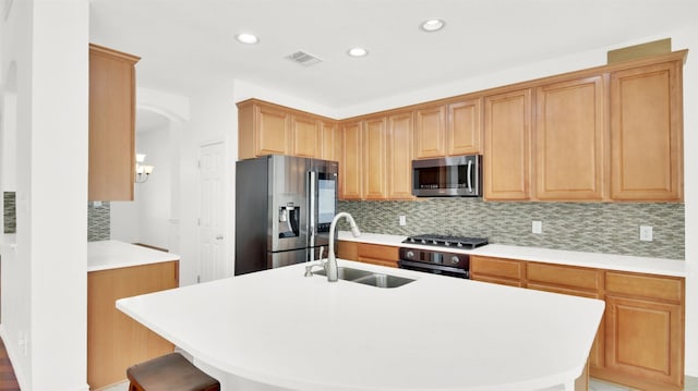 2310 Dervingham Dr, Cedar Park, TX 78613 - kitchen featuring stainless steel appliances, decorative backsplash, arched walkways, recessed lighting, and a kitchen island with sink