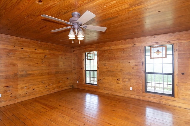 2874 Fm 1704, Elgin, TX 78621 - spare room featuring wooden ceiling, wood walls, ceiling fan, and wood-type flooring