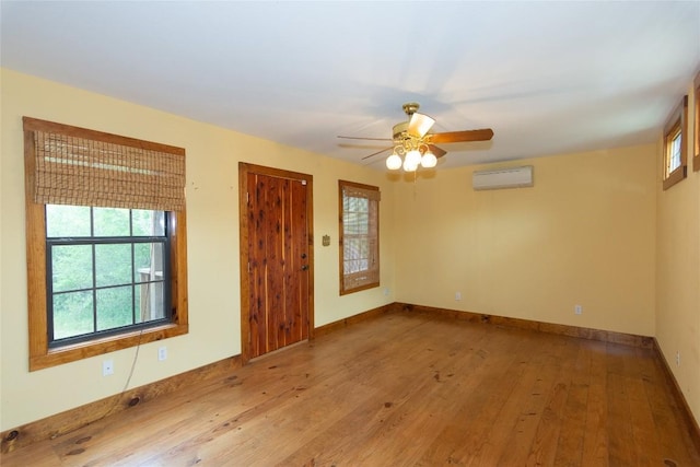2874 Fm 1704, Elgin, TX 78621 - spare room featuring a wall mounted air conditioner, healthy amount of natural light, and a ceiling fan