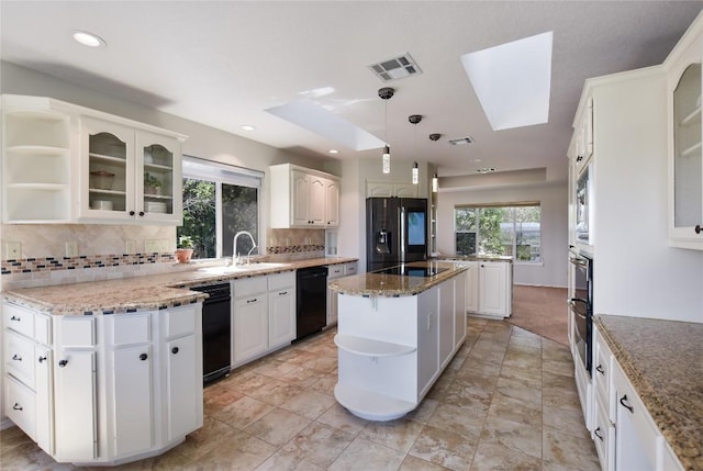 4705 Comanche, Lago Vista, TX 78645 - kitchen with open shelves, black appliances, a center island, decorative backsplash, and recessed lighting