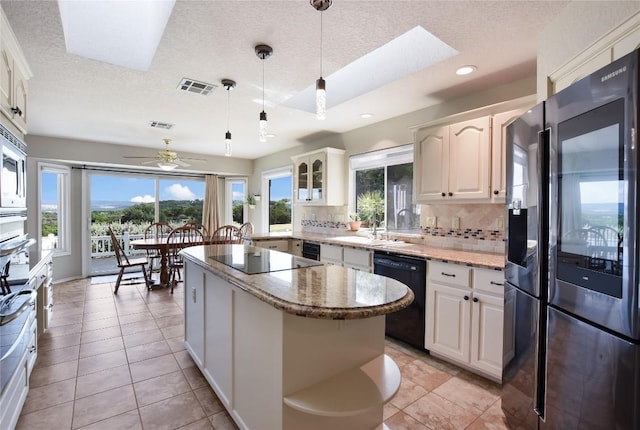 4705 Comanche, Lago Vista, TX 78645 - kitchen with black appliances, open shelves, a textured ceiling, tasteful backsplash, and light stone countertops