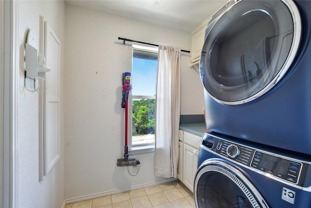 4705 Comanche, Lago Vista, TX 78645 - laundry area with stacked washer and clothes dryer, cabinet space, and light tile patterned floors