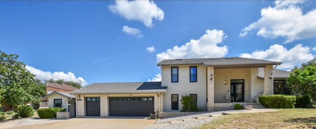 4705 Comanche, Lago Vista, TX 78645 - view of front of home featuring an attached garage, concrete driveway, and brick siding