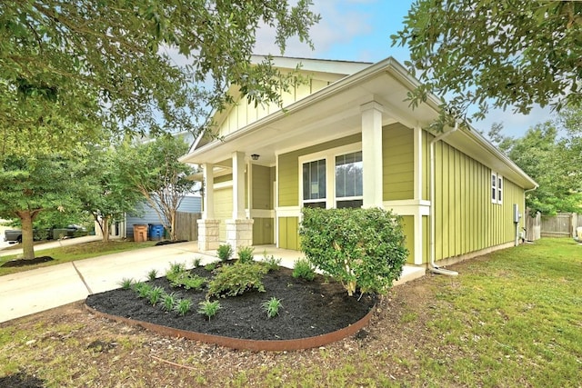 2911 Pops Way Unit 50, Austin, TX 78745 - view of side of home featuring board and batten siding, concrete driveway, and a garage