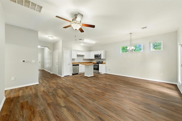 2911 Pops Way Unit 50, Austin, TX 78745 - unfurnished living room featuring ceiling fan, a chandelier, and dark wood-type flooring