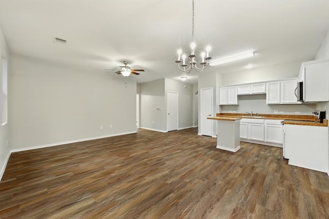2911 Pops Way Unit 50, Austin, TX 78745 - kitchen with open floor plan, ceiling fan, dark wood-style flooring, a chandelier, and white cabinetry