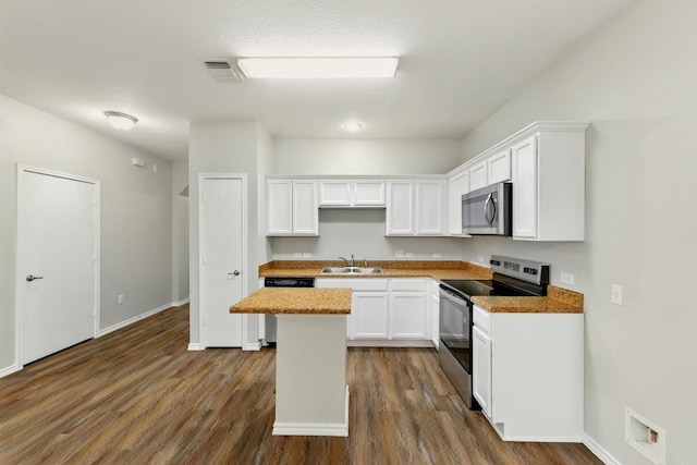 2911 Pops Way Unit 50, Austin, TX 78745 - kitchen featuring stainless steel appliances, white cabinets, and dark wood-style floors