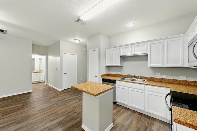 2911 Pops Way Unit 50, Austin, TX 78745 - kitchen with dishwasher, dark wood-style floors, white cabinets, black electric range oven, and a kitchen island