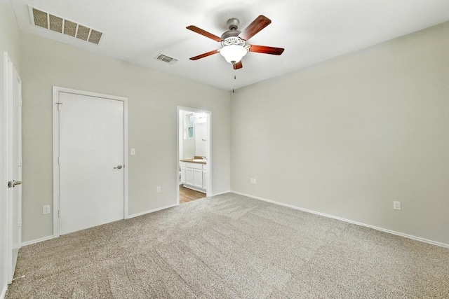 2911 Pops Way Unit 50, Austin, TX 78745 - unfurnished bedroom featuring carpet flooring, ensuite bathroom, and a ceiling fan