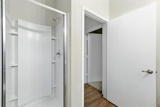 2911 Pops Way Unit 50, Austin, TX 78745 - full bathroom with a stall shower and wood finished floors