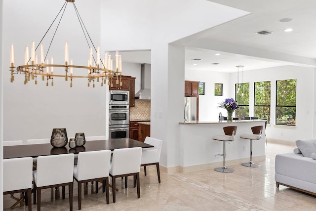 206 Lido St, Austin, TX 78734 - dining area featuring a chandelier, recessed lighting, and light marble finish flooring