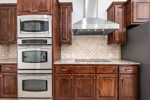 206 Lido St, Austin, TX 78734 - kitchen featuring stainless steel appliances, wall chimney range hood, decorative backsplash, and dark brown cabinetry