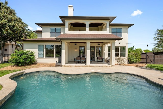 206 Lido St, Austin, TX 78734 - back of property featuring a fenced backyard, a patio, stucco siding, a chimney, and a balcony