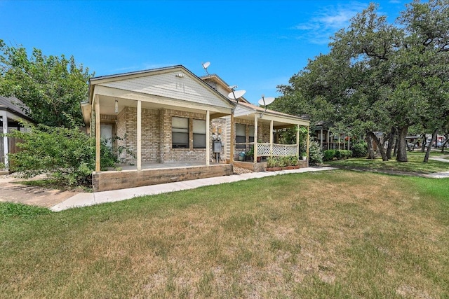 7825 Beauregard Cir Unit 25, Austin, TX 78745 - view of front facade with a porch, a front yard, and brick siding