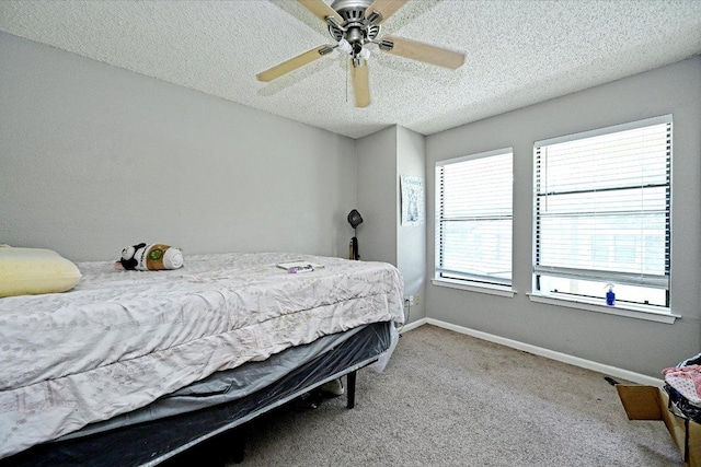 7825 Beauregard Cir Unit 25, Austin, TX 78745 - carpeted bedroom with a textured ceiling and a ceiling fan