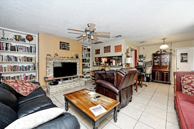 7825 Beauregard Cir Unit 25, Austin, TX 78745 - living area with light tile patterned floors, ceiling fan, a textured ceiling, and built in shelves
