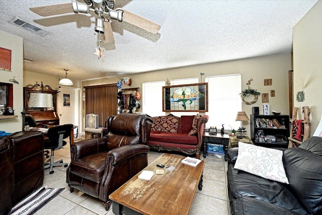 7825 Beauregard Cir Unit 25, Austin, TX 78745 - living room with light tile patterned flooring, a ceiling fan, and a textured ceiling