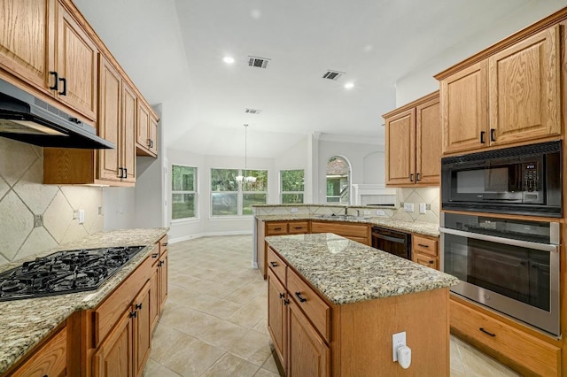 501 Flamingo Blvd, Lakeway, TX 78734 - kitchen featuring black appliances, backsplash, light stone countertops, a kitchen island, and under cabinet range hood