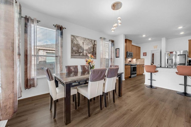 4909 Teverola Dr, Round Rock, TX 78665 - dining room featuring wood finished floors, healthy amount of natural light, and recessed lighting