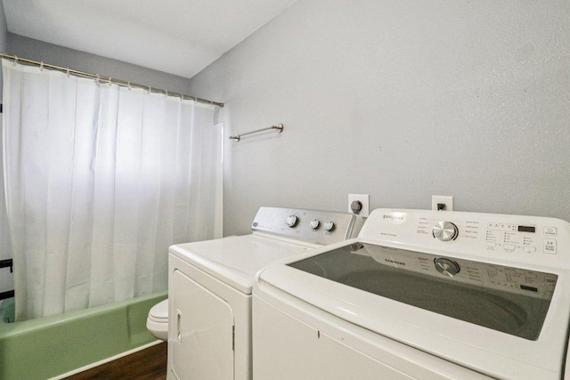 755 E Bellville St, Giddings, TX 78942 - laundry area featuring washer and clothes dryer and wood finished floors