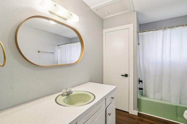 755 E Bellville St, Giddings, TX 78942 - full bathroom featuring vanity, wood finished floors, and shower / tub combo