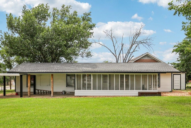 755 E Bellville St, Giddings, TX 78942 - rear view of house featuring a yard, a sunroom, and roof with shingles