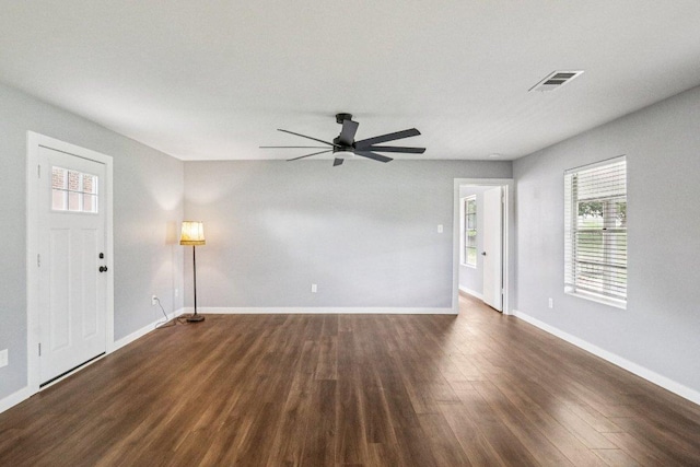 755 E Bellville St, Giddings, TX 78942 - spare room featuring dark wood-style floors and a ceiling fan
