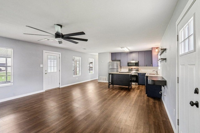 755 E Bellville St, Giddings, TX 78942 - living area with dark wood finished floors and a ceiling fan