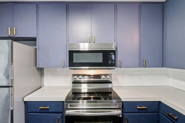 755 E Bellville St, Giddings, TX 78942 - kitchen featuring stainless steel appliances, blue cabinets, light countertops, and backsplash