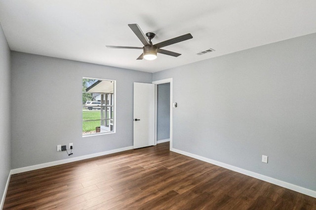 755 E Bellville St, Giddings, TX 78942 - spare room with dark wood-style flooring and ceiling fan