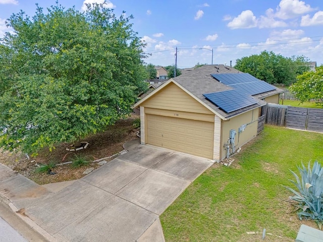 15300 Lucian St, Austin, TX 78725 - view of front of property with roof mounted solar panels, driveway, and a garage
