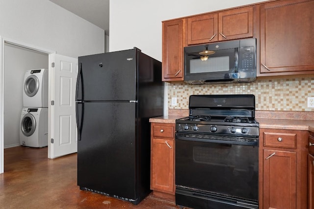 15300 Lucian St, Austin, TX 78725 - kitchen featuring black appliances, stacked washer / drying machine, backsplash, brown cabinets, and light countertops
