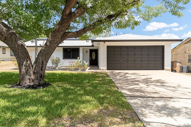 8312 Roan Ln, Austin, TX 78736 - single story home with brick siding, a garage, concrete driveway, and a front yard