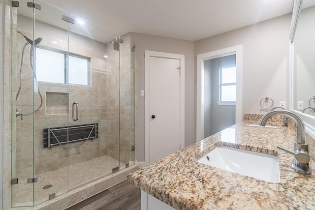 8312 Roan Ln, Austin, TX 78736 - full bath featuring double vanity, wood finished floors, and a stall shower