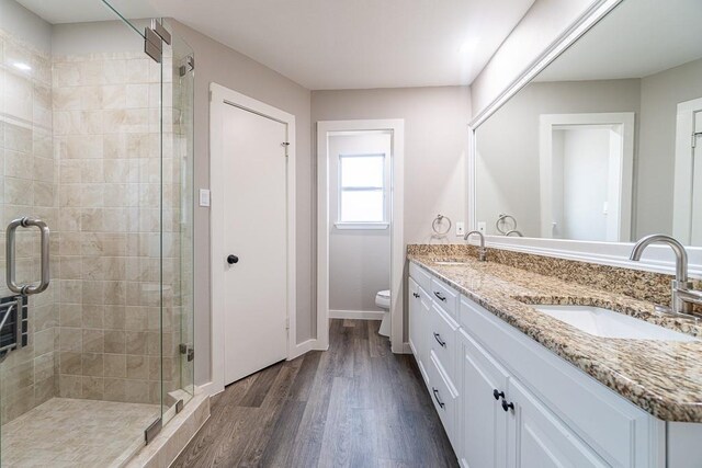 8312 Roan Ln, Austin, TX 78736 - full bath featuring double vanity, a stall shower, and wood finished floors