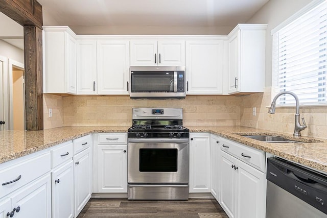 8312 Roan Ln, Austin, TX 78736 - kitchen featuring appliances with stainless steel finishes, white cabinetry, and light stone counters