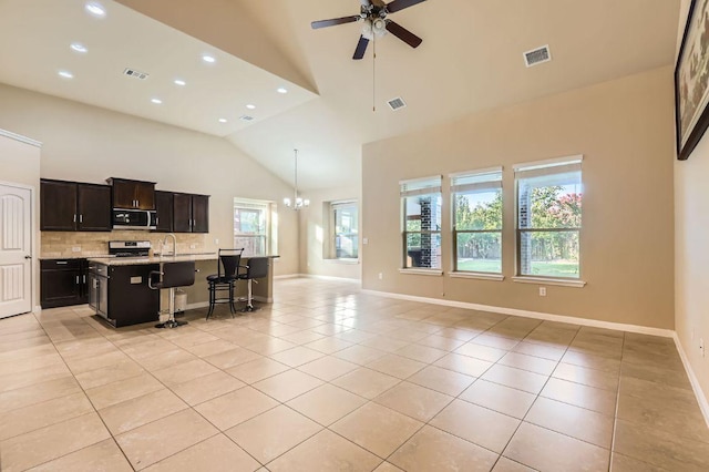 16225 Chianti Cv, Pflugerville, TX 78660 - living room featuring light tile patterned floors, a ceiling fan, recessed lighting, a chandelier, and high vaulted ceiling
