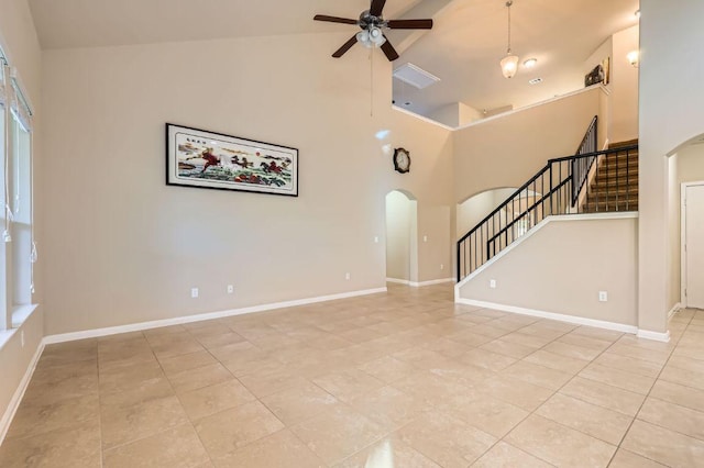 16225 Chianti Cv, Pflugerville, TX 78660 - unfurnished living room with arched walkways, high vaulted ceiling, a ceiling fan, light tile patterned flooring, and stairway