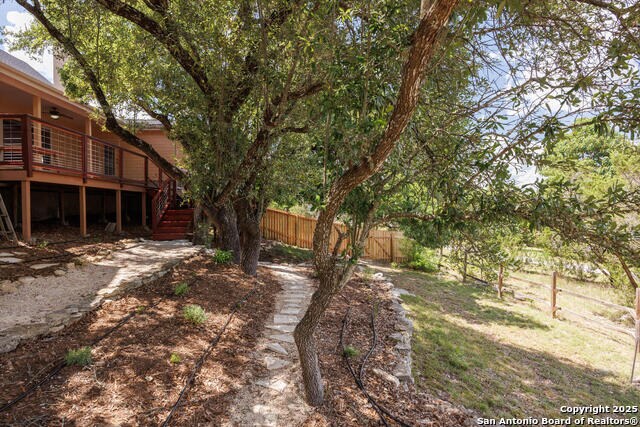 2291 Frontier Dr, Spring Branch, TX 78070 - view of yard featuring a deck and stairway
