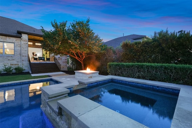 405 Maialina Cv, Lakeway, TX 78738 - pool at dusk with a fire pit, an outdoor pool, and a patio area