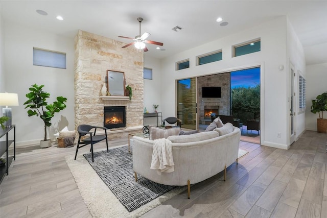 405 Maialina Cv, Lakeway, TX 78738 - living area featuring a fireplace, ceiling fan, light wood-type flooring, and recessed lighting