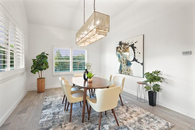 405 Maialina Cv, Lakeway, TX 78738 - dining space with wood finished floors, a chandelier, and a towering ceiling
