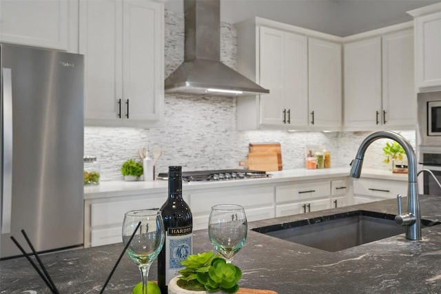 405 Maialina Cv, Lakeway, TX 78738 - kitchen featuring stainless steel appliances, wall chimney range hood, white cabinetry, and tasteful backsplash