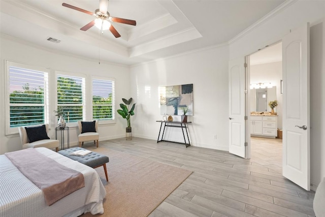 405 Maialina Cv, Lakeway, TX 78738 - bedroom with light wood-style floors, a tray ceiling, ornamental molding, ensuite bathroom, and ceiling fan