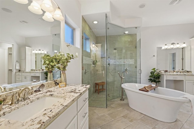 405 Maialina Cv, Lakeway, TX 78738 - bathroom featuring a stall shower, a freestanding tub, and two vanities