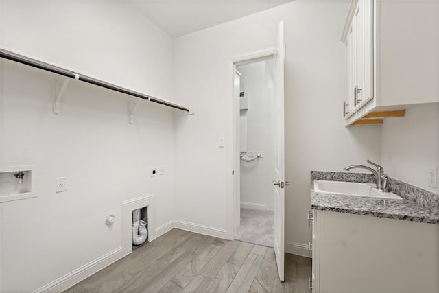 405 Maialina Cv, Lakeway, TX 78738 - laundry room featuring cabinet space, hookup for an electric dryer, light wood-type flooring, gas dryer hookup, and washer hookup
