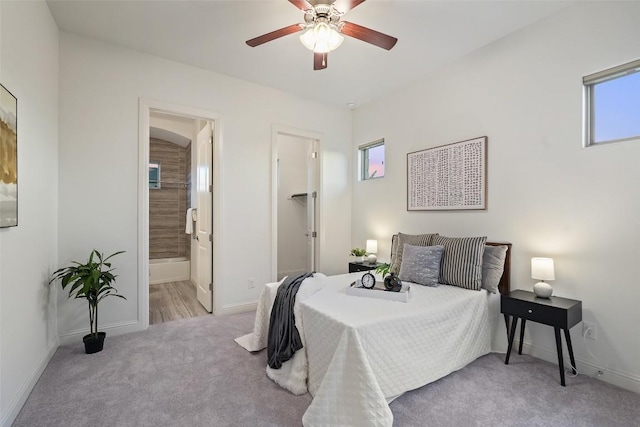 405 Maialina Cv, Lakeway, TX 78738 - carpeted bedroom with multiple windows, a ceiling fan, and ensuite bath